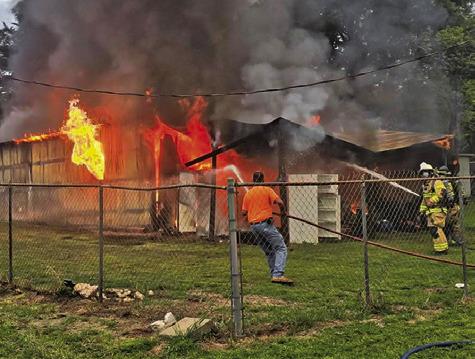FIREFIGHTERS SPRAY WATER on this workshop on April 7 off Elm Drive at Cade Lake. Caldwell and Deanville firefighters responded. Photo courtesy of Caldwell Volunteer Fire Department
