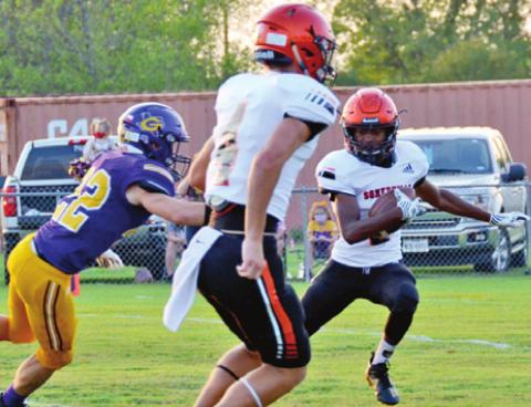 SOMERVILLE’S VERKOBE WOODBERRY breaks free against Grangers last Friday. Also pictured is Johnny Legg, center.