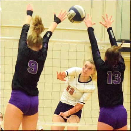 CALDWELL’S MARLEY MAURER hits the ball between the attempted blocks of Lamar Fulshear’s Skylar Voskuhl and Shelby Tally. Maurer MARLEY MAURER led the team in kills with 13. -- Tribune photo by Denise Hornaday