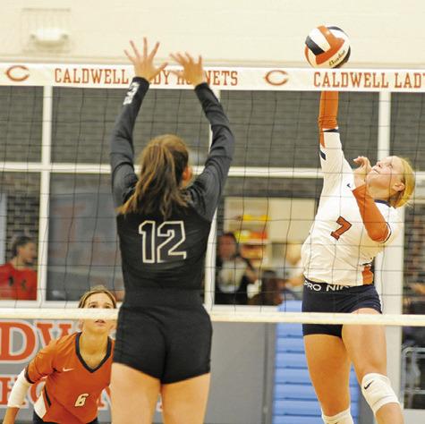 CALDWELL’S CAITLYN FAUST hits the ball over the net during the Lady Hornet’s loss to Sealy last Friday night in Hornet Gym.