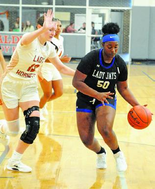 ROZARIA CARTER dribbles past Kaely Brown during last Tuesday’s Caldwell-Snook game at Hornet Gym. Tribune photo by Denise Squier
