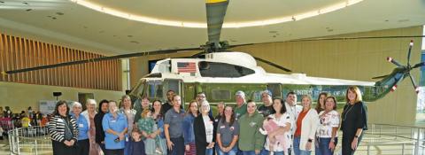 MEMBERS OF BURLESON COUNTY NONPROFIT organizations which participated in the annual Brazos Valley Gives posed in front of this helicopter at the Marine One/4141 Locomotive Pavilion at the George Bush Library on the campus of Texas A&amp;M University during Brazos Valley Gives’ award event last Wednesday. See story inside. Tribune photo by Denise Squier