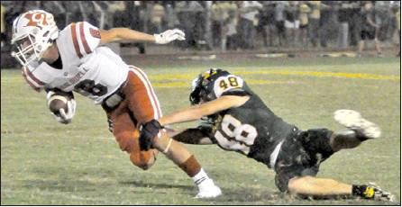 LOGAN KNESEK GETS away from this Lexington defender last Friday in Lexington. Caldwell’s defense excelled in a 20-8 victory, and the Hornets improved to 2-3. -- Tribune photo by Roy Sanders