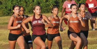 THE LADY HORNET VARSITY cross country team begins running its race at Saturday’s Caldwell XC Invitational. Tribune photo by Roy Sanders