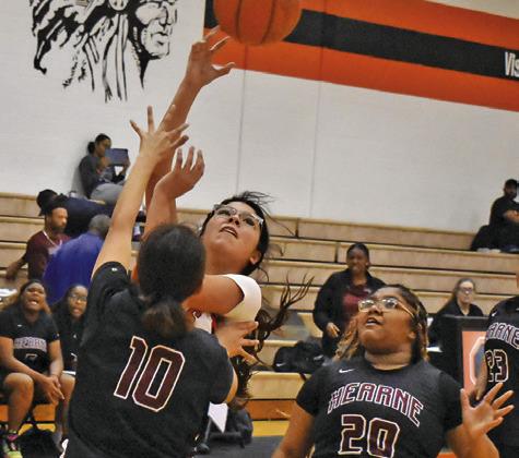 SOMERVILLE’S ARABELLA OROZCO takes a shot over Hearne’s Fernanda Luna while Hearne’s Katelyn Martinez watches. Tribune photo by Roy Sanders