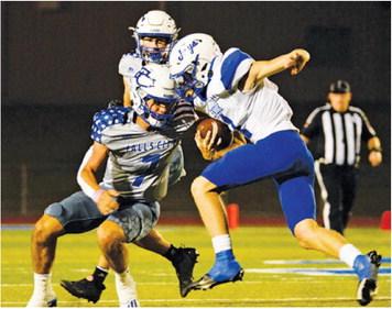 SNOOK’S LIAM ZEQUERIA carries the ball against Falls City in last Friday’s road game. -- Photo courtesy of Marion Laskowski