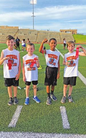 SOMERVILLE YOUTH SPORTS competed at the Bryan Thunderbolts Invitational Track Meet on June 30. Pictured are, from left, Jaxton Groce, Jaxson Schoppe, Elijah Pleasant and Conner Richardson.