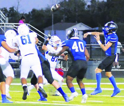 BRETT WITHEM OF Snook hurls this pass against Bartlett. Tribune photo by Denise Squier