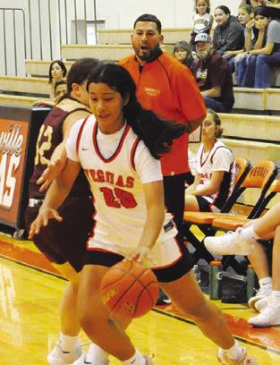 ANNETTE REYNA dribbles past a Milano player during the Lady Yeguas’ 51-20 loss to Milano last Friday. Reyna scored three points in the loss. Tribune photo by Denise Squier