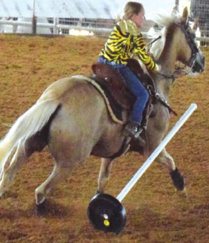 THIS RIDER KNOCKS over a pole during the Burleson County Saddle Club’s Youth Rodeo on Saturday. -- Tribune photo by Denise Squier