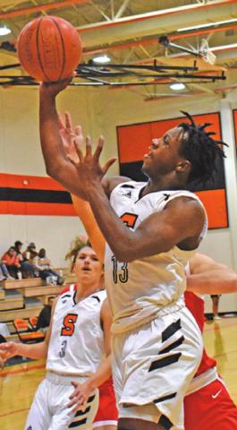 D.J. BRYANT SHOOTS the ball during the Somerville-Bellville game last Tuesday night. Also pictured is Johnny Legg.