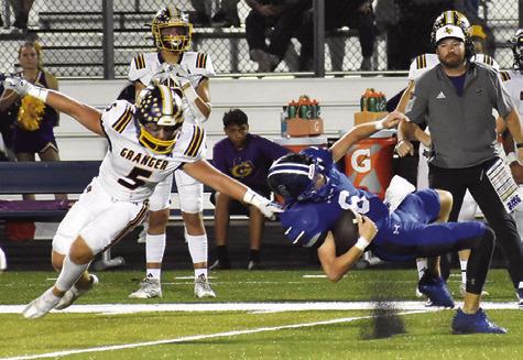 SNOOK QUARTERBACK BRETT Withem falls as this Granger defender approaches in last Friday’s game in Snook. Tribune photo by Roy Sanders