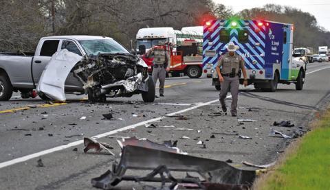 DPS TROOPERS WORK THE scene of this accident on State Highway 36 South on Sunday. Tribune photo by Roy Sanders