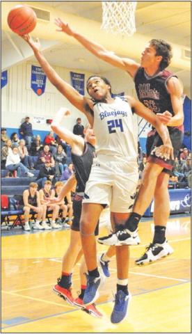 DEKENDRICK DAWSON TAKES a shot dedpite heavy defensive pressure against Iola. -- Tribune photo by Denise Squier