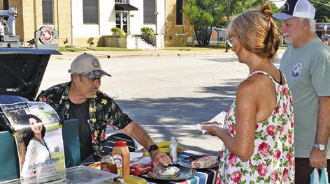 JIM HARRELL MAKES a sale at the Farmers Market on Saturday in downtown Caldwell.