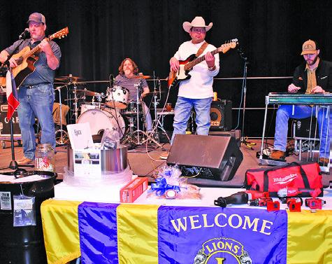 THE CROSSROADS BAND plays on Saturday night at the Denim Dinner and Dance held by the Caldwell Burleson County Lions Club at the Caldwell Civic Center. A live auction was also held. Tribune photo by Roy Sanders