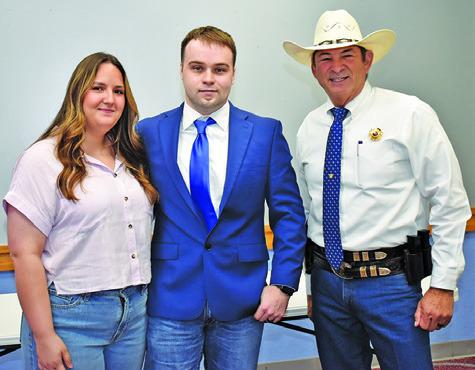 TEEX ACADEMY CADET Dylan Bryant is joined by Sheriff Bill Rios on Monday at the swearing in ceremony at the Caldwell Civic Center.