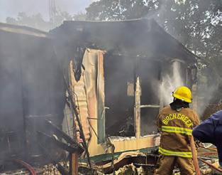 A BIRCH CREEK firefighter battles this house fire last Friday at Shady Oaks Drive at Somerville Place Subdivision. Photo courtesy of Birch Creek VFD.