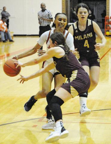 SOMERVILLE’S DESTINY VELA STRUGGLES to drive the ball past a Milano defender during the Lady Yeguas’ win over the Lady Eagles last Friday night in Somerville. -- Tribune photo by Denise Squier