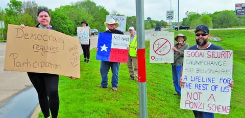 DEMONSTRATORS CALLING THEMSELVES “Patriots Against Elon Musk” line State Highway 21 at the new Tesla charging station in Caldwell as one of the over 200 “Tesla Takedown” protests across the nation on Saturday. Photo courtesy of Kassandra Langley