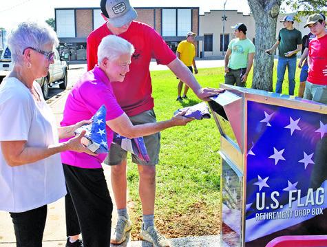 BEVERLY BROADDUS IS the first to drop off a flag at the flag retirement drop box on Sunday. Joining her is Becky Strauss and Alex York. Also pictured, in back, are Russell Ramirez, John Alford, Paul Johnson and Jackson Berndt. See story inside. Tribune photo by Roy Sanders