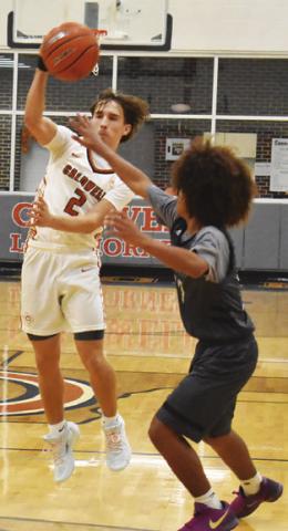 NATHAN HERMES passes the ball against Bryan JV in the round one game of the Kolache Capital Tournament in Caldwell. Tribune photo by Roy Sanders