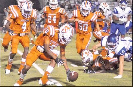 LARRY DAVIS OF THE Caldwell Hornets moves in to recover this fumble last Friday against the Edna Cowboys in Caldwell. The Hornets lost their season opener 29-16 and will face Rockdale this Friday in Rockdale. -- Tribune photo by Roy Sanders