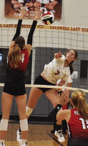 LYDIA GIESE gets the ball past a BVCHEA Homeschool blocker during Caldwell’s win Friday night. This week, Giese reached a milestone of 1,000 career assists. Tribune photo by Roy Sanders