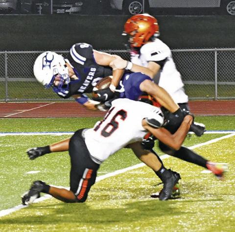 SOMERVILLE DEFENDERS, including Gardner Shivers, front, make a tackle against Falls City. -- Photo by Marian Laskowski