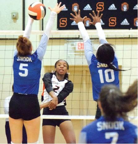 SOMERVILLE’S RAMAYA CARTER hits the ball through the block of Snook’s Kenzie Kmiec. Also pictured are Snook’s Jaivan Stringfellow and Natalie Vacha. -- Tribune photo by Denise Hornaday
