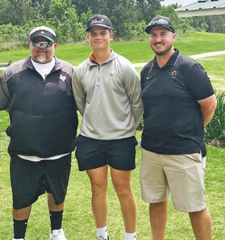COOPER SCHLUENS IS joined by Assistant Coach Rene Cantu, left, and Head Coach Jacob Schaefer, right, at the regional tournament.