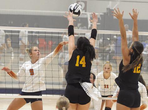 CALDWELL’S MOLLY MEADOWS hits the ball into the hands of Klein Oak’s Tori Leggeiro and Ava Marr during Caldwell’s match against Klein Oak at last week’s Legends Invitational tournament. Tribune photo by Denise Squier