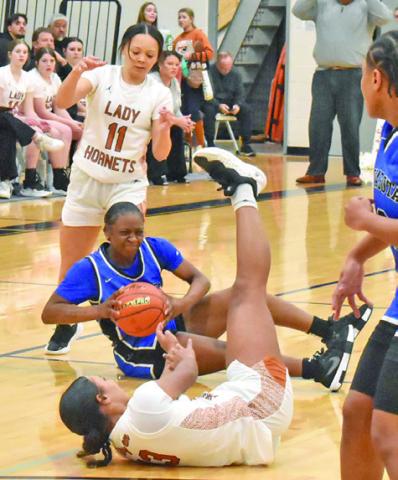 SEVERAL LADY HORNETS scramble for possession with a Navasota player during Caldwell’s 48-21 loss to Navasota last Friday night. Tribune photo by Roy Sanders