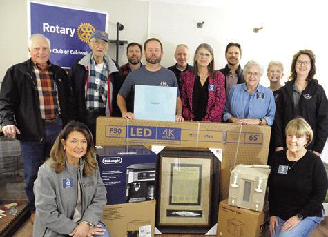 THE ROTARY CLUB OF Caldwell is gearing up for this Saturday’s annual “Casino Night” at the Burleson County Expo Center. Pictured are Rotary Club members with some of the prizes that event goers may win during the event’s prize drawings. Tribune photo by Denise Squier