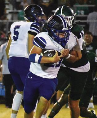MICHAEL EATON carries the ball for Snook last Friday against Normangee. Tribune photo by Roy Sanders