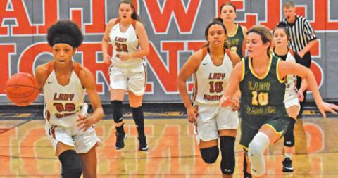 CALDWELL’S JAE MATHIS drives down the court during the Lady Hornets’ win over Lexington last Friday. Also pictured is Ava Jones.