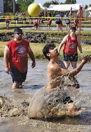 A MUD VOLLEYBALL player goes for the ball last Saturday during Hog Splash 2026 at Slovacek’s in Snook. The popular, annual event benefits Hospice Brazos Valley. Tribune photo by Roy Sanders