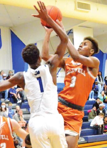 DONTAVIEN JOHNSON of Caldwell shoots as Ma’Darius Hamilton of Snook tries to block the shot. -- Tribune photo by Roy Sanders