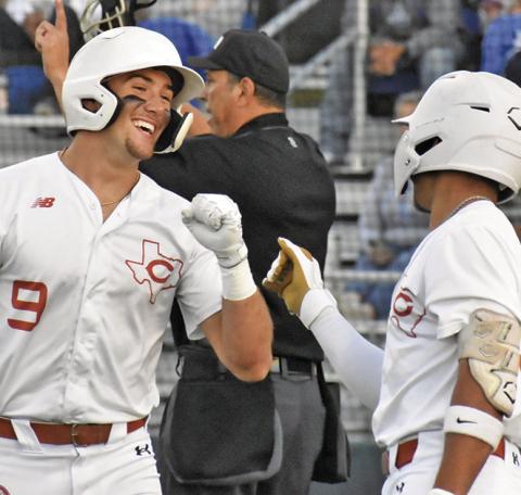 COY BECKA AND Zane Brown celebrate Becka’s score in last Thursday’s game against Anderson Shiro. Caldwell won 6-3. Tribune photo by Roy Sanders