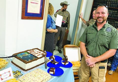 DUANE STRANGE STANDS next to his farewell cake presented by county officials.