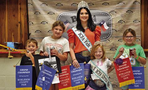 JUDE, CAROLINE AND LYNNDEE MCDERMOTT won grands in Children’s Corner Creative Arts and Crafts and Junior Creative Arts and Crafts, Canned Foods and Needlework. Also pictured are Fair Queen Kodi Hitchcock and Little Miss Taytum Hohlt. Tribune photo by Sabine Lazo
