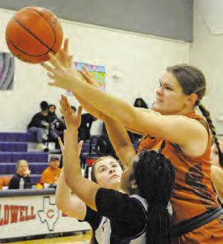 RILEY BROADDUS reaches over several Lady Jays for possession of the ball during the Caldwell-Snook game last week during the Lady Hornet Basketball Tournament.