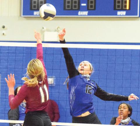 SNOOK’S RILEY GREEN hits the ball over Fayetteville’s Kayme Schley during the Lady Jays’ four-set loss to the Lady Lions last Tuesday night in Snook. -- Tribune photo by Denise Hornaday