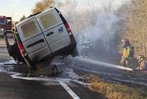 FIREFIGHTERS WORK THE scene of this U.S. Postal Service van fire on Wednesday, Dec. 31, off F.M. 3058. Photo courtesy of Caldwell Volunteer Fire Department