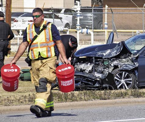 A CALDWELL FIREFIGHTER works the scene of this accident on Monday afternoon on State Highway 21 East in Caldwell. Details on the accident were not available at press time. Tribune photo by Roy Sanders