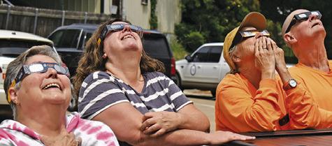 RESIDENTS ENJOY THE solar eclipse on Monday afternoon, April 8, at the Harrie P. Woodwon Memorial Library in Caldwell.
