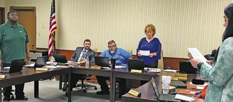 SOMERVILLE ISD’S NINFA STEVENS gives the oath of office to newly elected returning board members, David Idlebird and Melissa Tharp during last Wednesday’s board meeting.