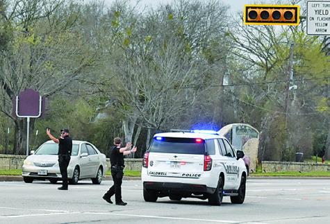 CALDWELL POLICE OFFICERS direct traffic at the State Highway 21 and Main Street intersection on Monday, March 2, during the electric power outage in Caldwell. See story inside.