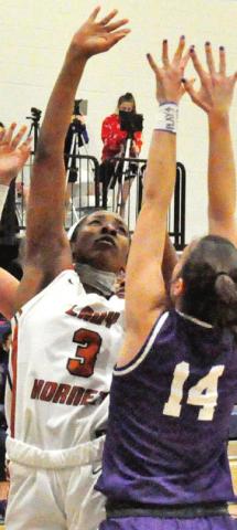 AIYLIYA BELL SHOOTS over Florence’s Abbey Brown in the Lady Hornets’ 47-21 win last Friday night. -- Tribune photo by Roy Sanders