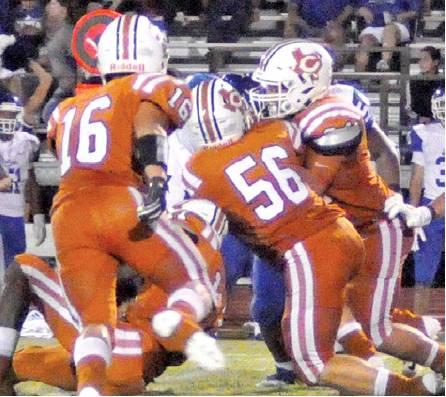 COLLIN GAMMAGE AND Carson Gammage move in for this tackle last Friday against Edna in Caldwell. The Hornets lost 29-16 in the opener and face Rockdale this week. -- Tribune photo by Roy Sanders